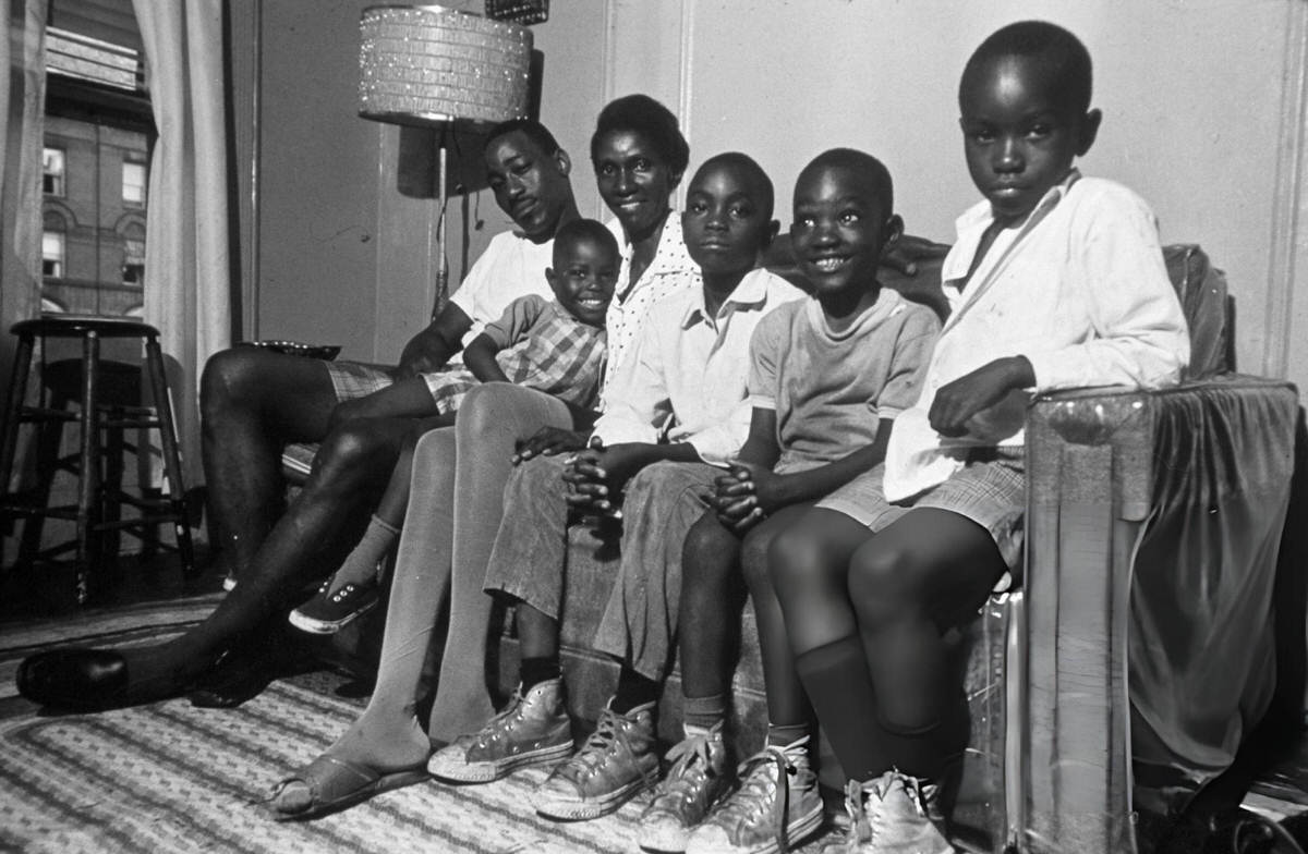 Family Sitting On A Sofa In Their Harlem Home, 1970.
