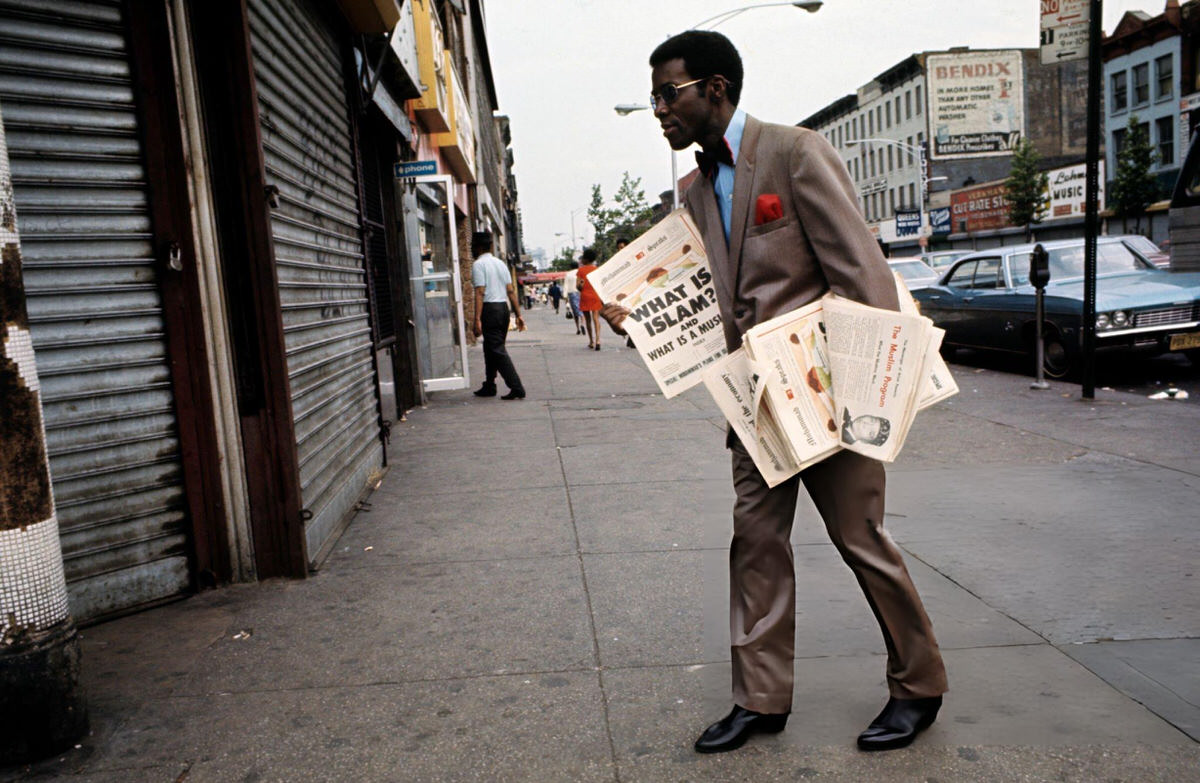 Man Distributing Newspapers About Islam On A Harlem Street, 1970.