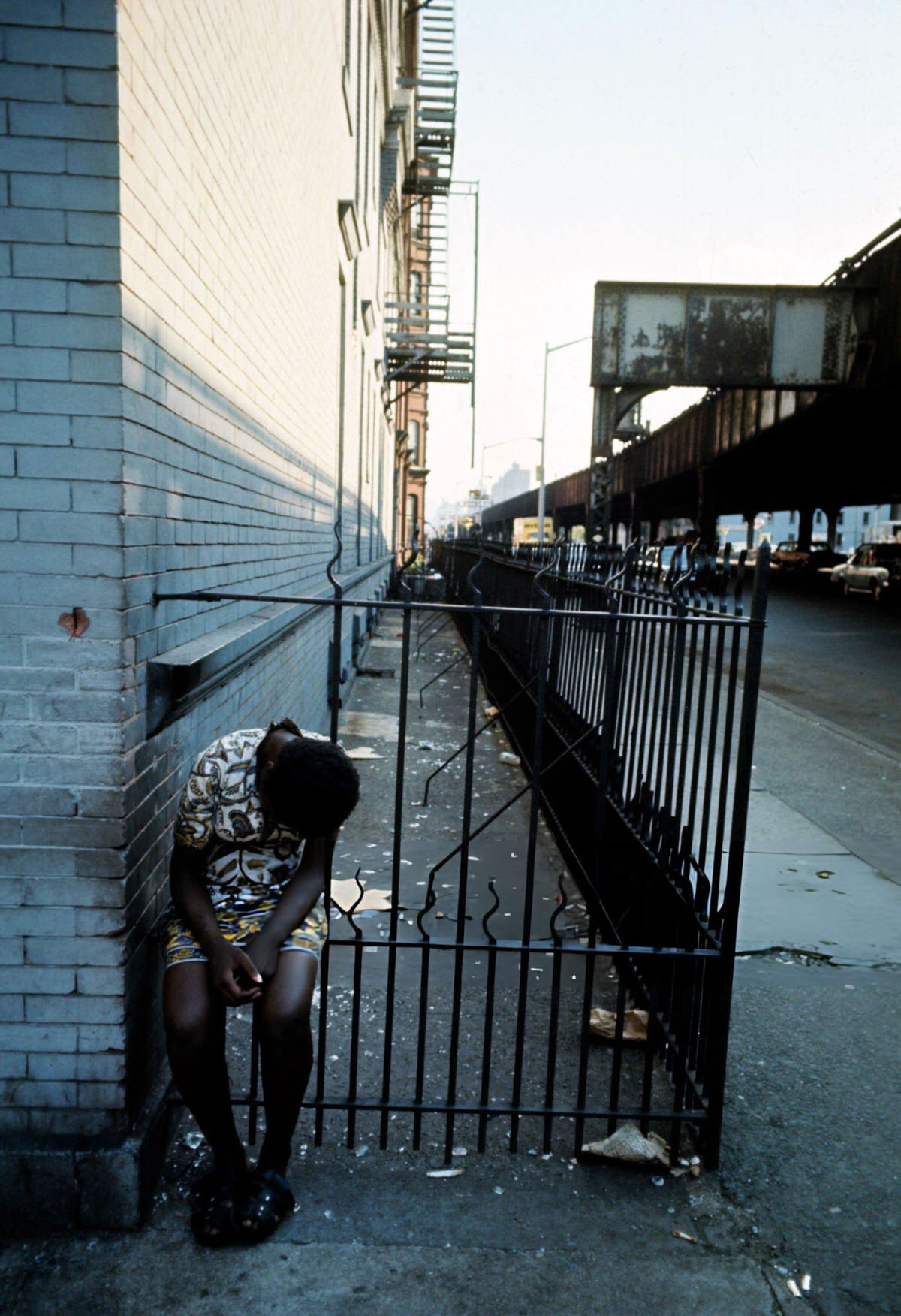 Young Woman Sitting On A Street Grate, Harlem, 1970.