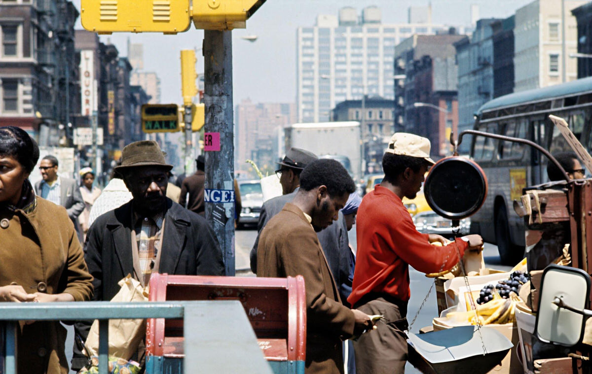 Vendor Weighing Grapes And Bananas On A Harlem Sidewalk, 1970.