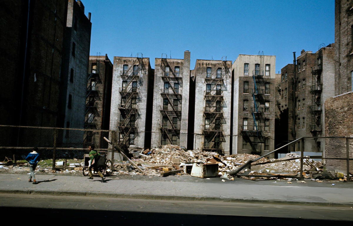 Children Playing In Front Of A Vacant Lot Strewn With Debris, Harlem, 1970.