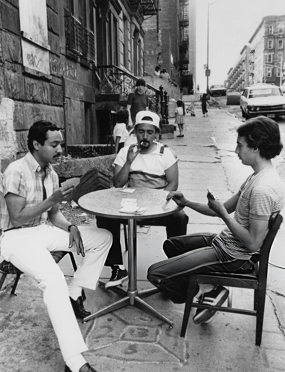Men Playing Cards In The Street, East Harlem, 1975.