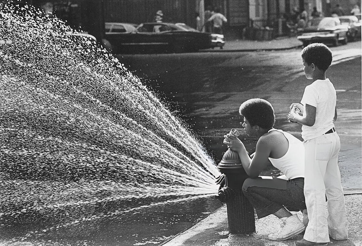 Children Standing Near An Open Fire Hydrant After The 1977 Blackout, Harlem, 1977.