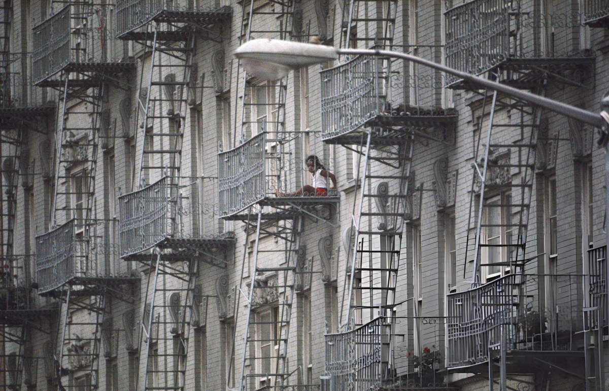 Girl On A Fire Escape In Harlem During The Summer, 1985.