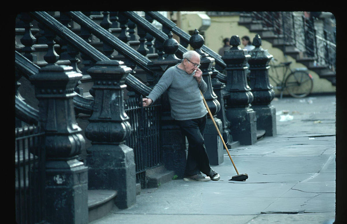 Elderly Man Taking A Break From Sweeping, Harlem, 1986.