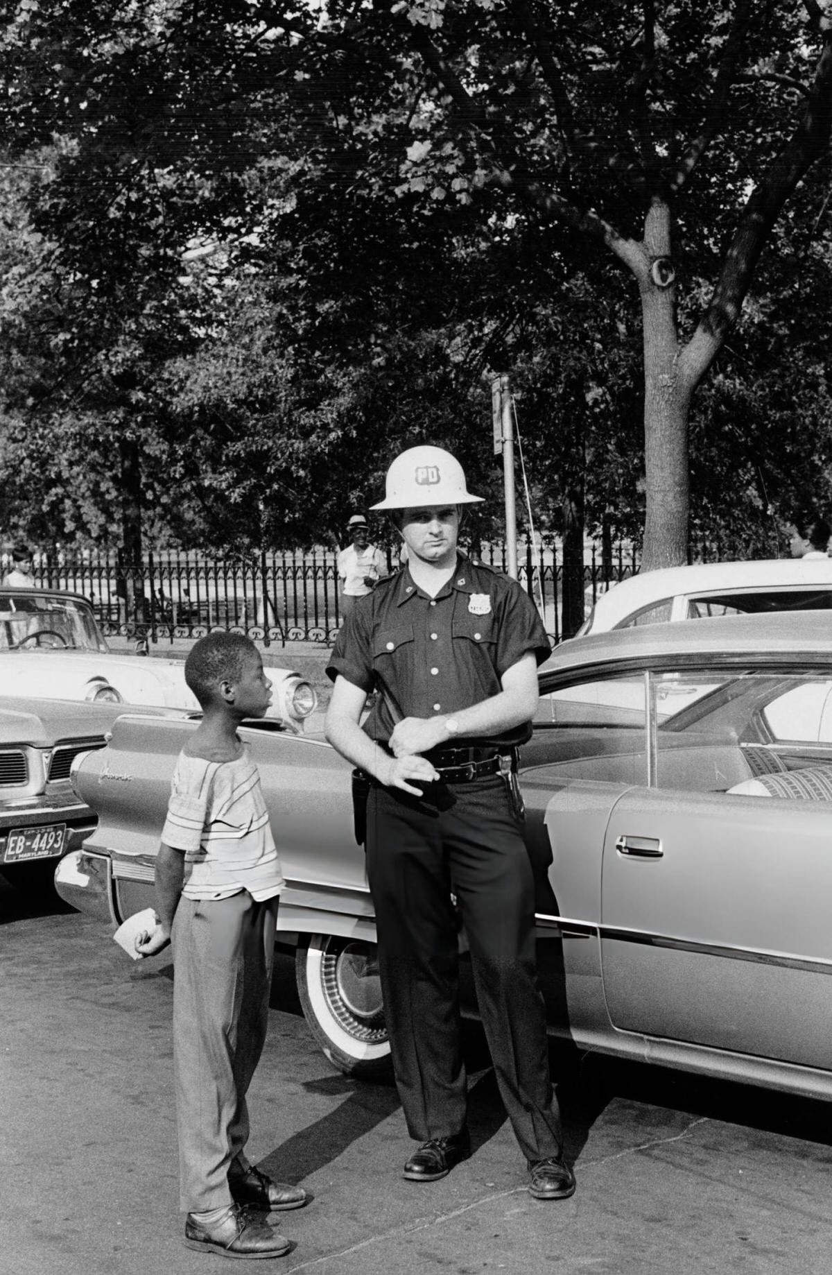 Young Boy Speaking To A Police Officer During The Harlem Riots, 1964.