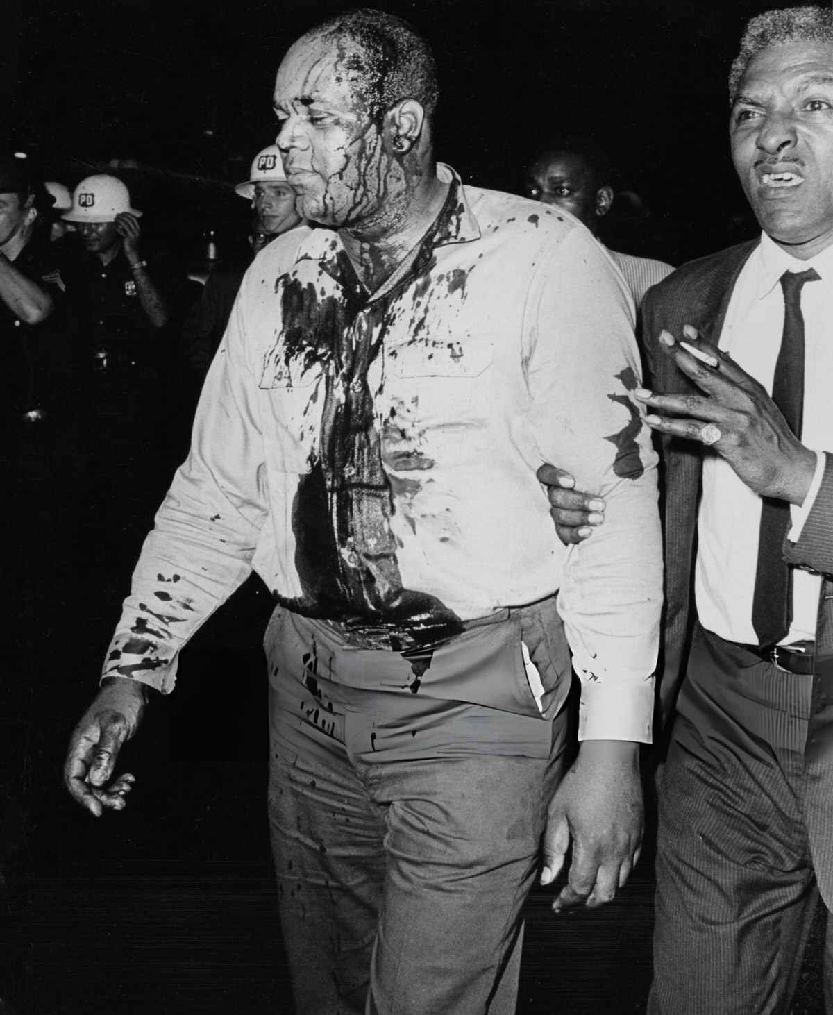 Bayard Rustin Escorting An Injured Man Through Harlem During The 1964 Riots.