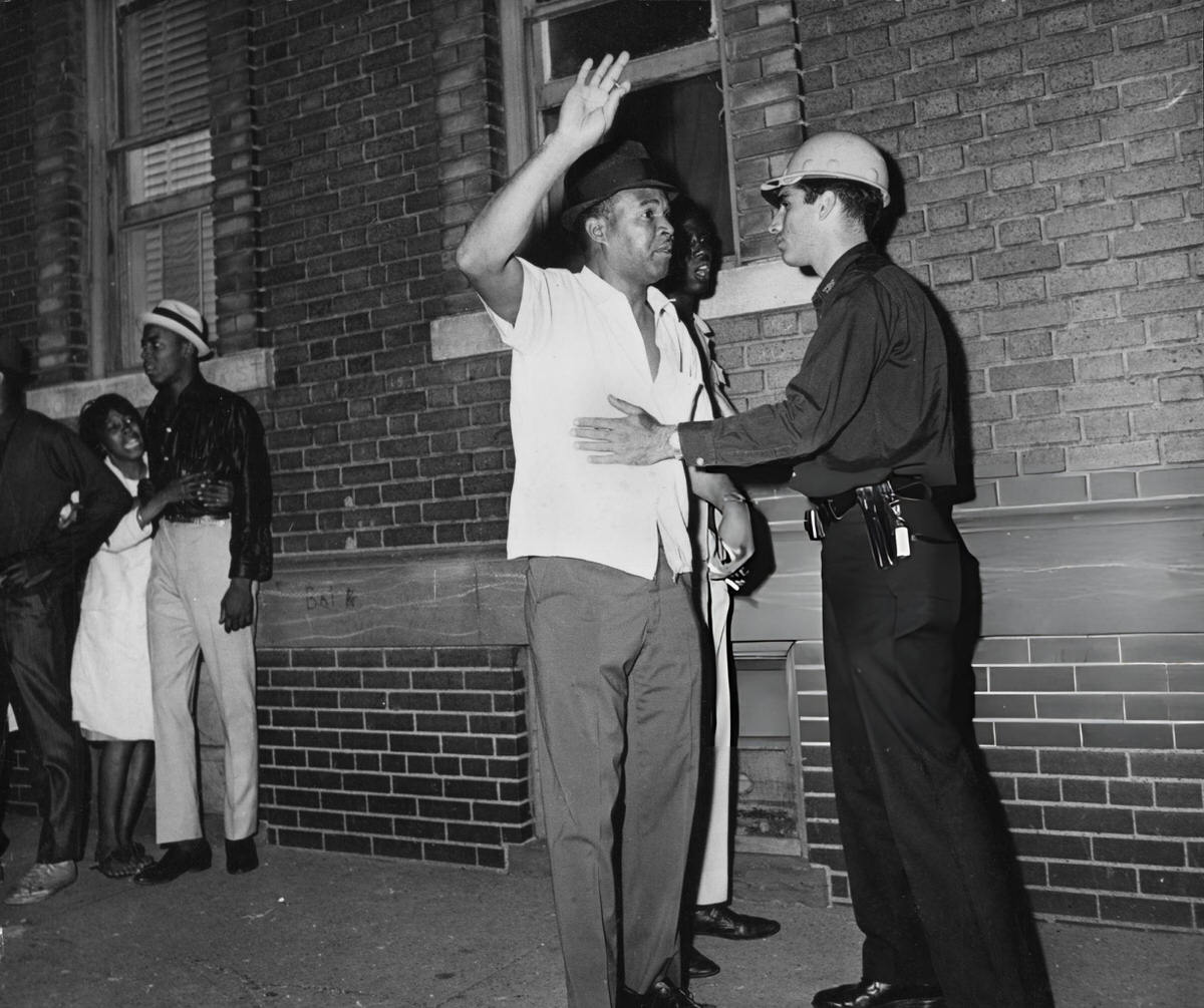 Police Officer Searching A Man In Brooklyn As The Harlem Riots Spread, 1964.