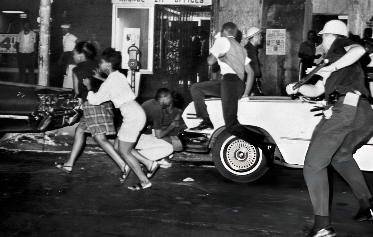 Rioters Scattering As A Police Officer Charges The Crowd At 129Th Street And Seventh Avenue, Harlem, 1964.