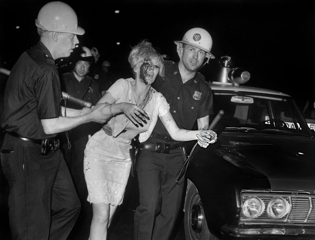 Police Assisting An Injured Woman During The Harlem Riots, 1964.