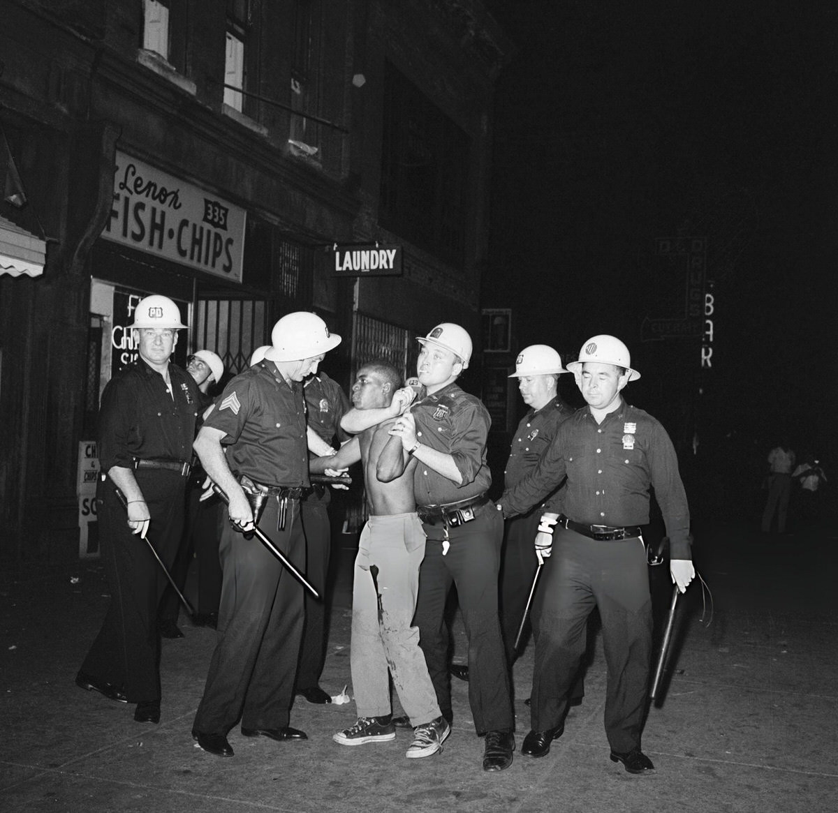Police Arresting A Protester Shot In The Leg During The Harlem Riots, 1964.