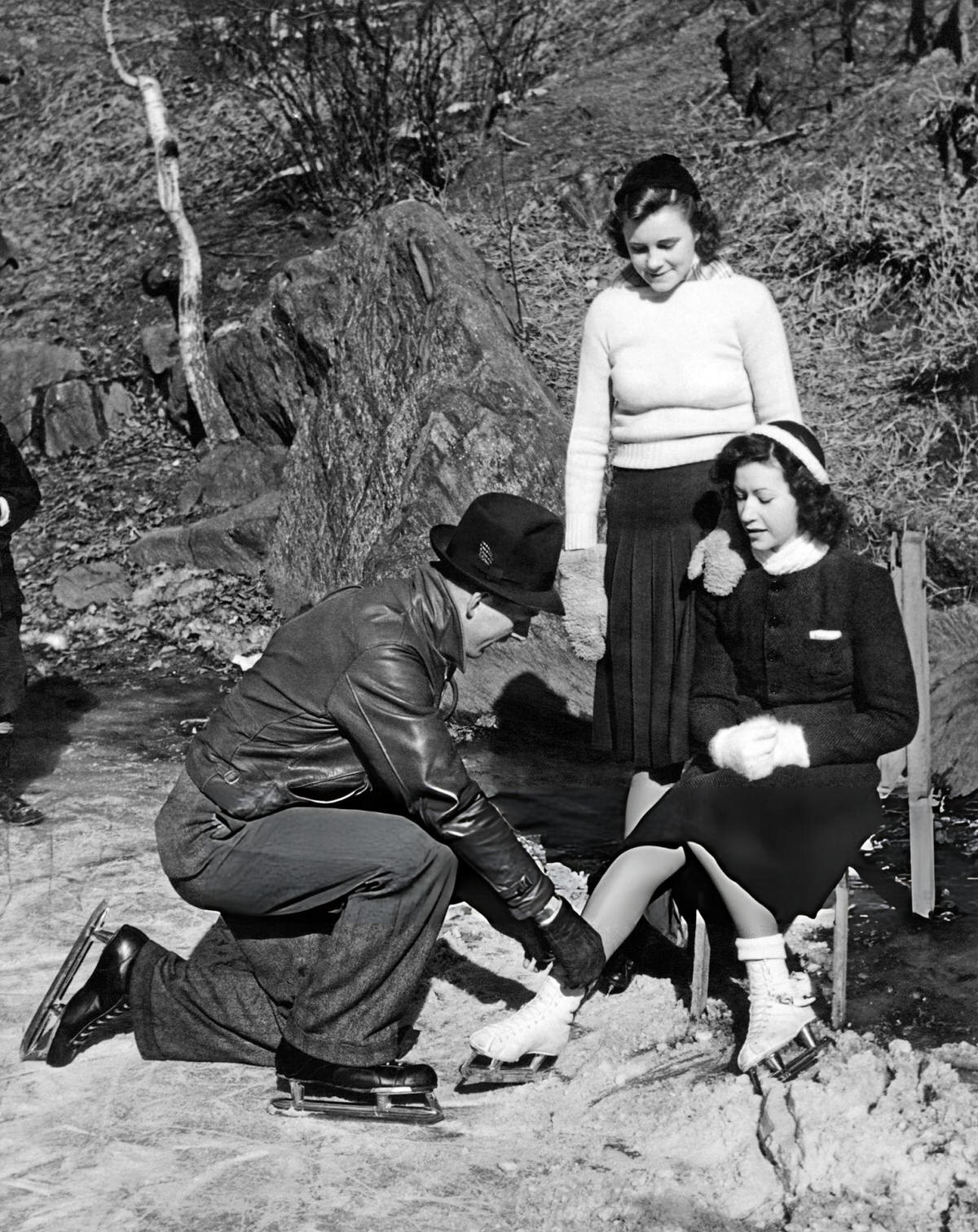 Man Helping A Woman With Her Skates On The Lake In Central Park, New York, 1932.