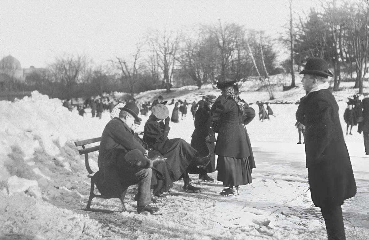 Family Preparing To Ice Skate On A Frozen Pond In Central Park, New York, 1890S.
