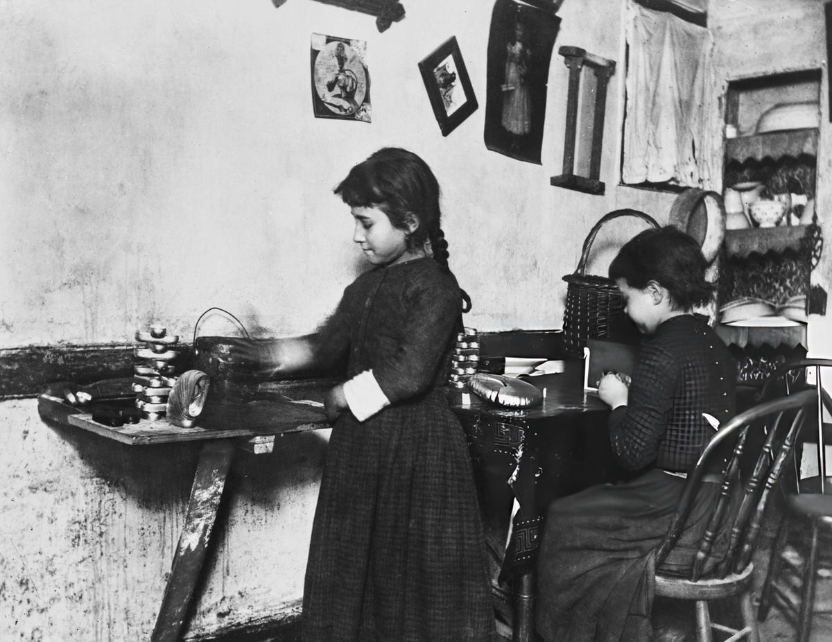 Two Young Girls Doing Metal Work In A Tenement Room, New York, 1890.