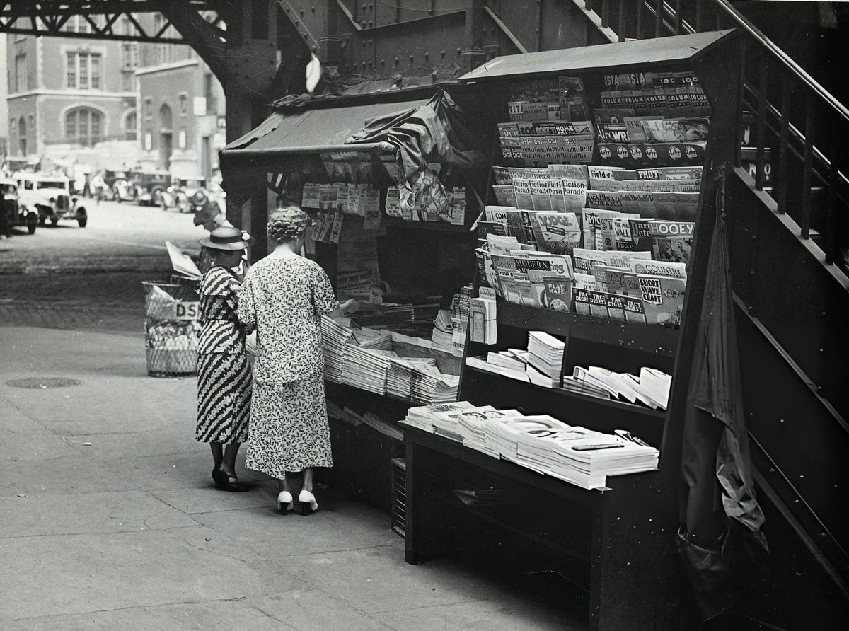 Two Women Looking At Newspapers At A Stand On Third Avenue And 42Nd Street, New York, 1930.