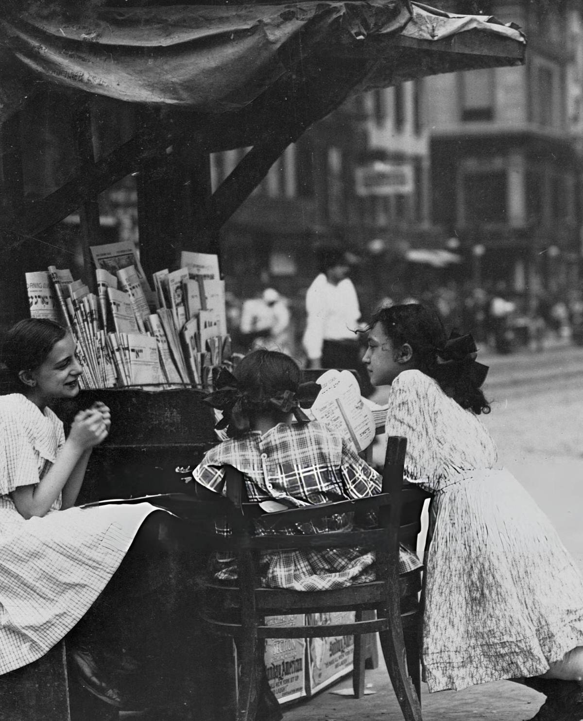 Three Young Girls Selling Papers From A Newsstand On Canal Street, New York.