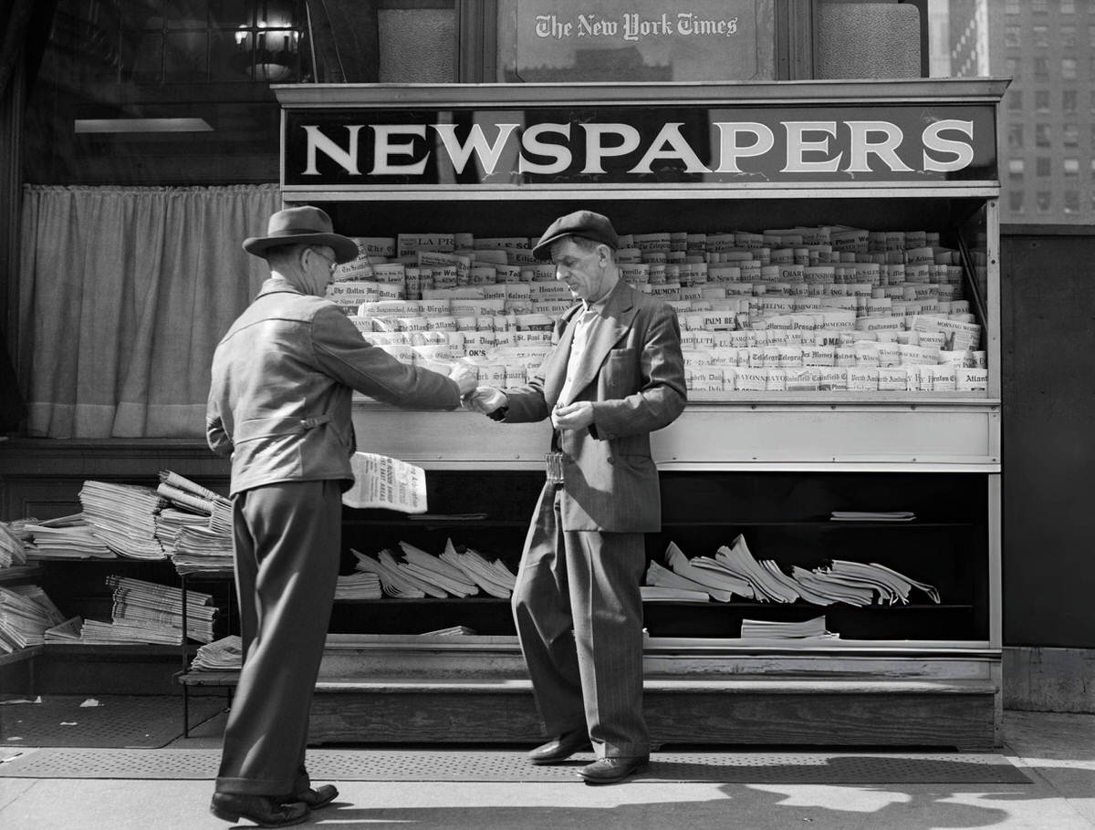 Man Buying A Newspaper From A Sidewalk Vendor, New York, 1940S.