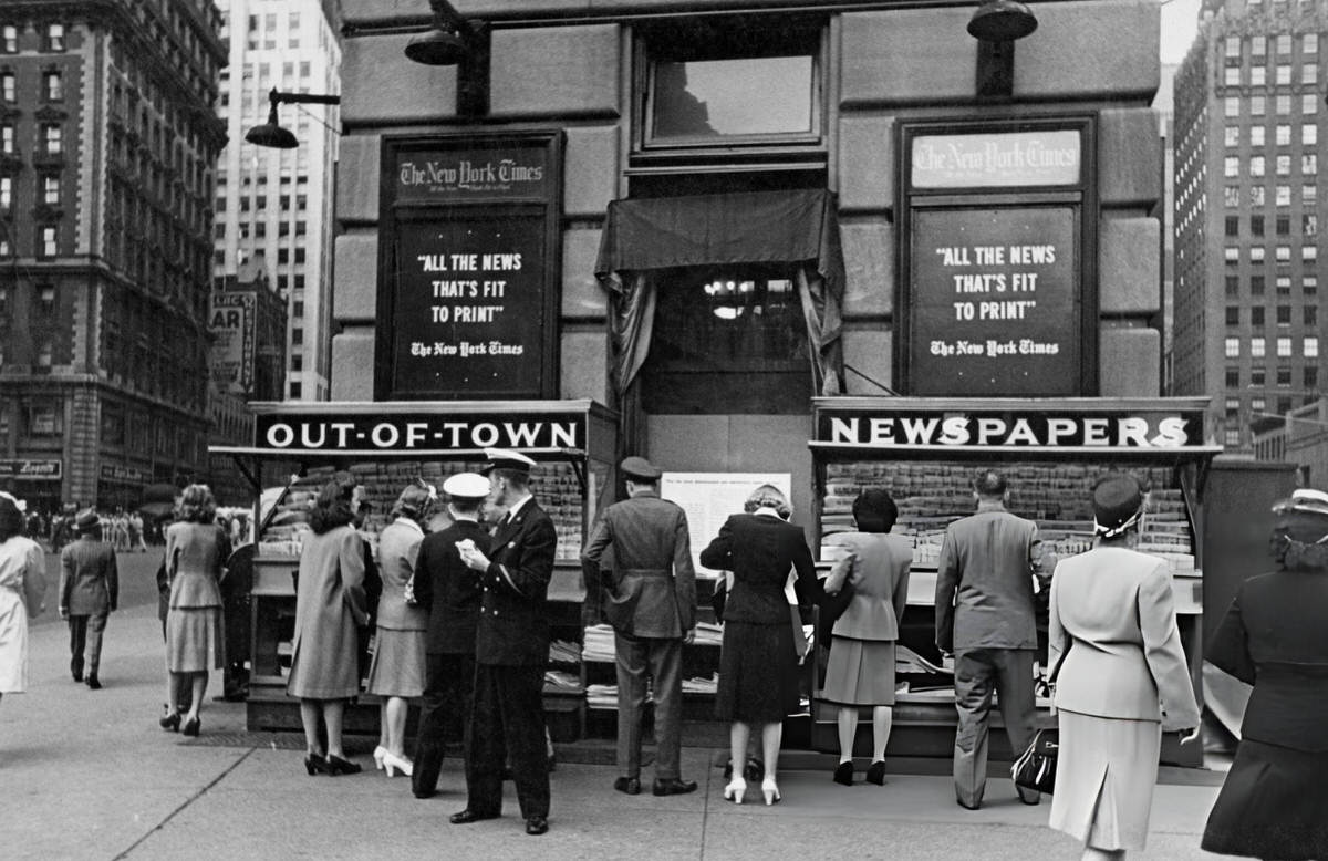 Pedestrians Browsing An Out-Of-Town Newsstand Outside The New York Times Offices, Manhattan, 1945.