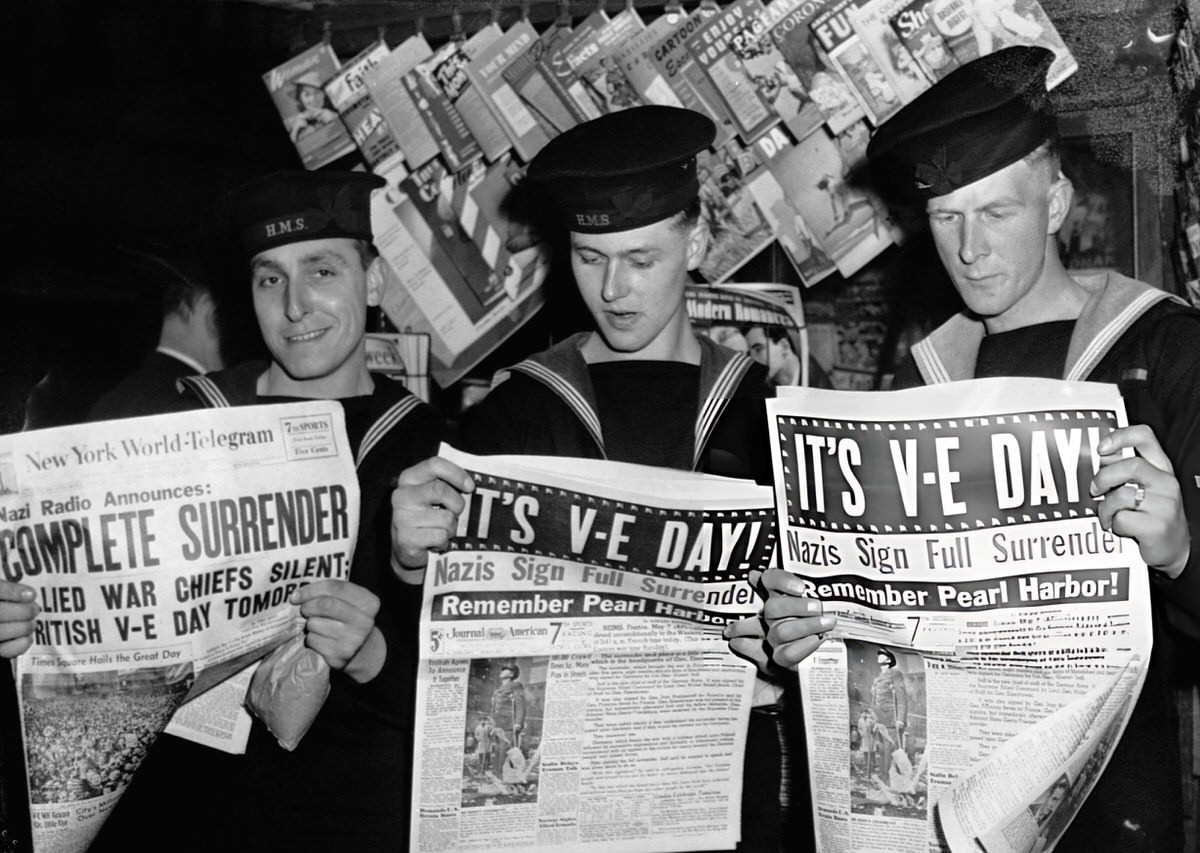 British Sailors In New York Reading Reports Of The German Surrender, 1945.