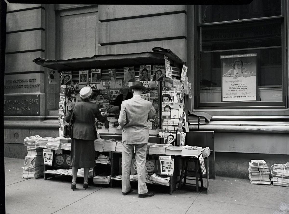 Man And Woman At A Newsstand Outside A Bank, New York, 1950.