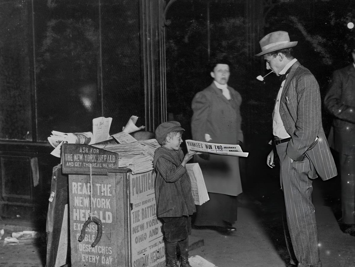 Seven-Year-Old Newsboy Selling A Paper To A Businessman At Columbus Circle, New York, 1910S.