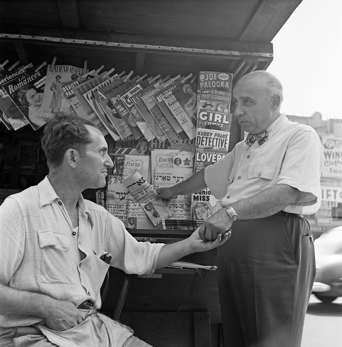 Man Buying A Jewish Newspaper From A Kiosk On The Lower East Side, Manhattan, 1955.