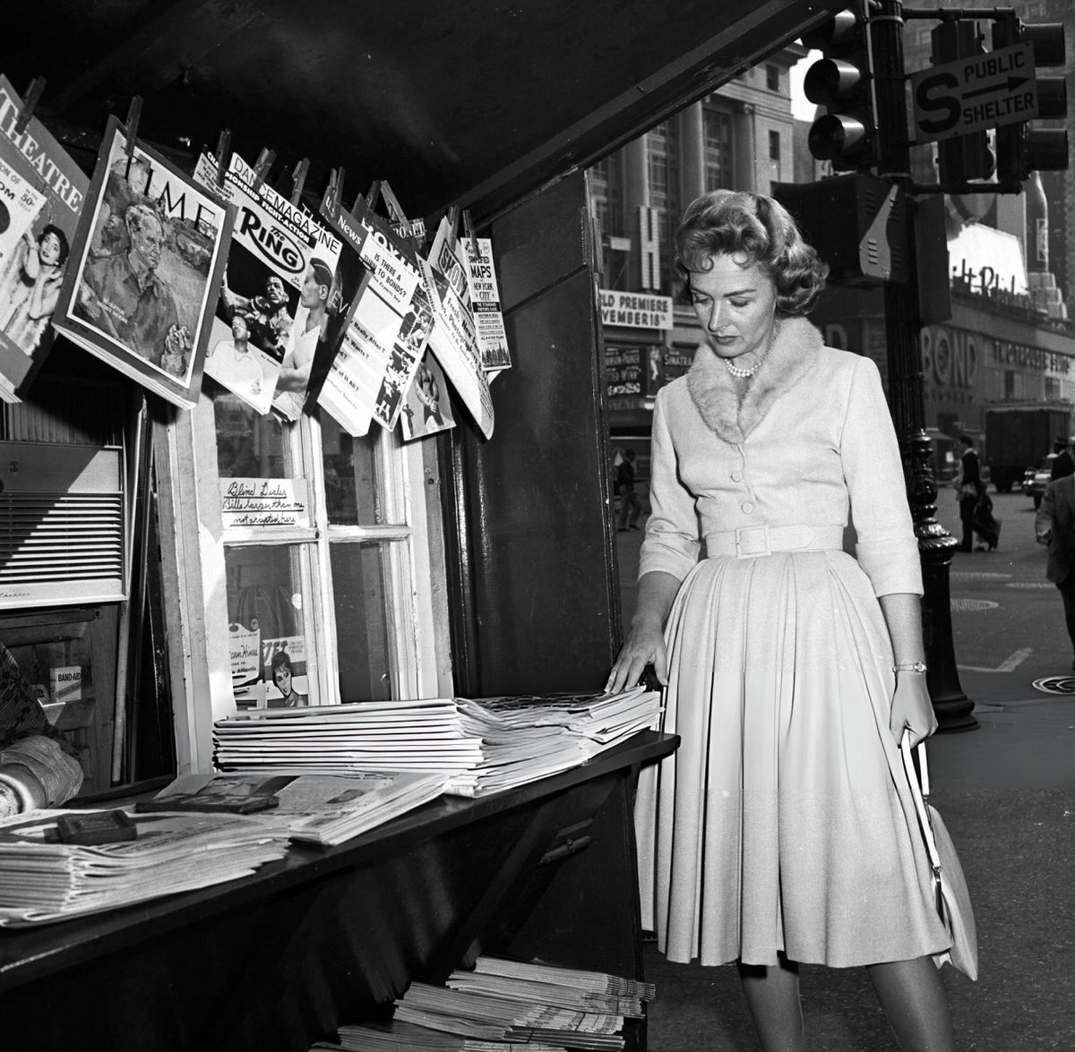 Donna Reed Looking At Newspapers At A Newsstand, New York, 1959.