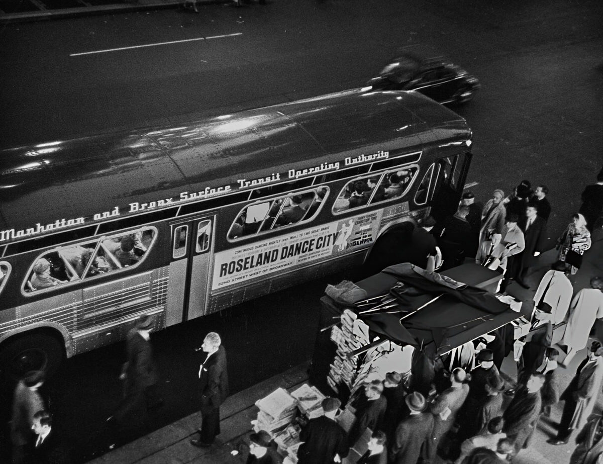 Bus With A Roseland Dancehall Advertisement Passing A Newsstand, New York, 1960.