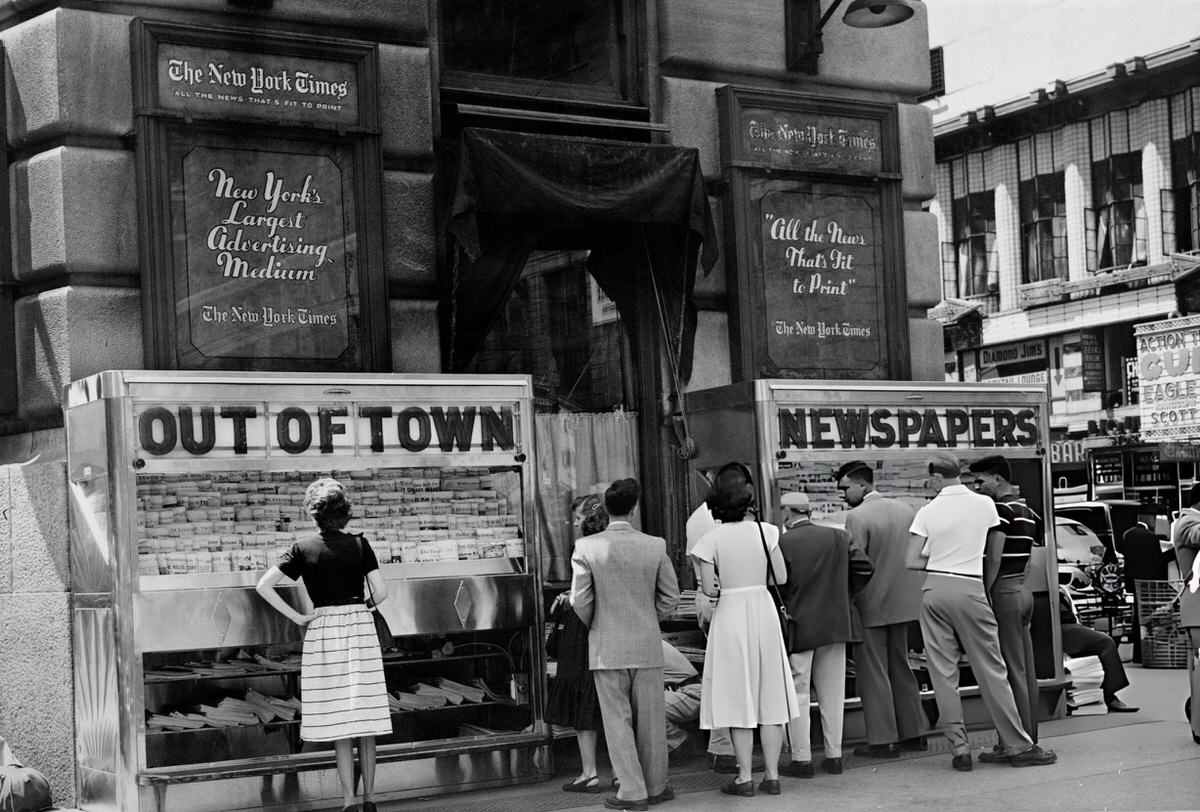 Pedestrians At An Out-Of-Town Newsstand Outside The New York Times Building, Midtown Manhattan, 1965.