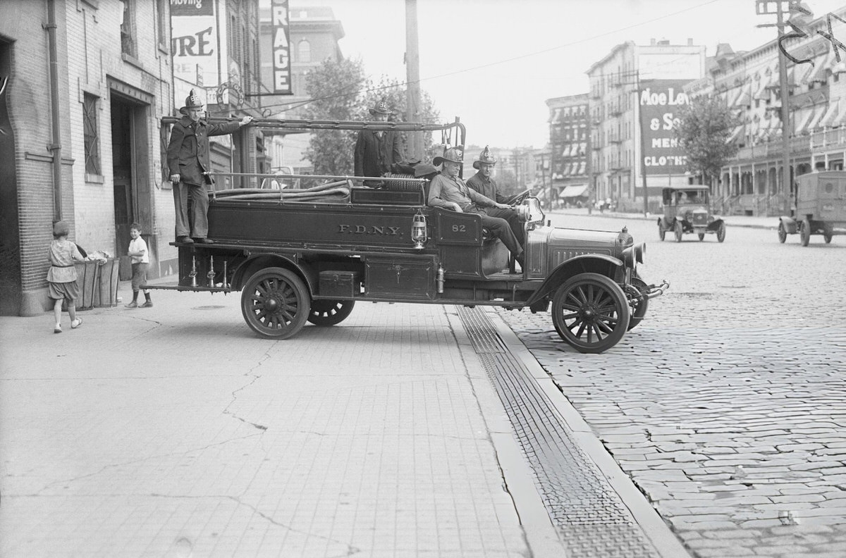 Fire Chief And Firefighters With Their Engines Outside A Manhattan Firehouse.