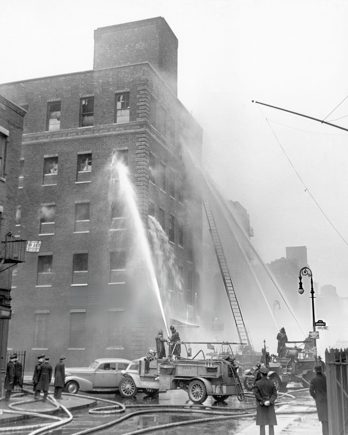 Firefighters Extinguishing A Blaze At A Mattress Factory Loft Building, New York.