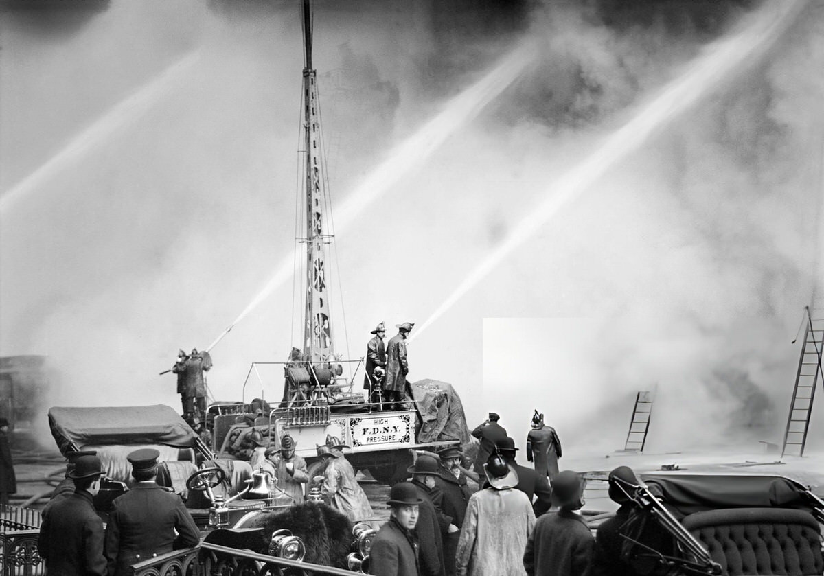 Firefighter Spraying Water On A Burning Building On 14Th Street, New York, 1909.