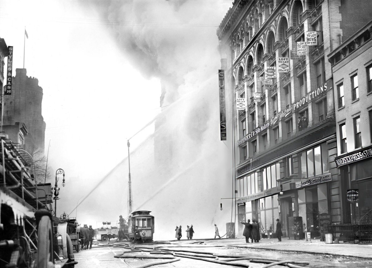 Firefighter Spraying Water On A Burning Building On 14Th Street, New York, 1909.