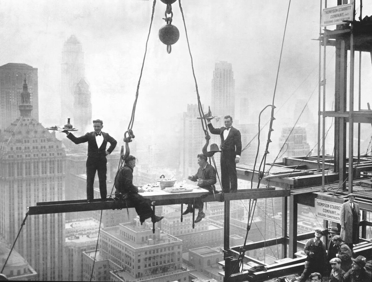 Waiters Serving Steel Workers On Girders During The Construction Of The Waldorf-Astoria Hotel, New York, 1930.