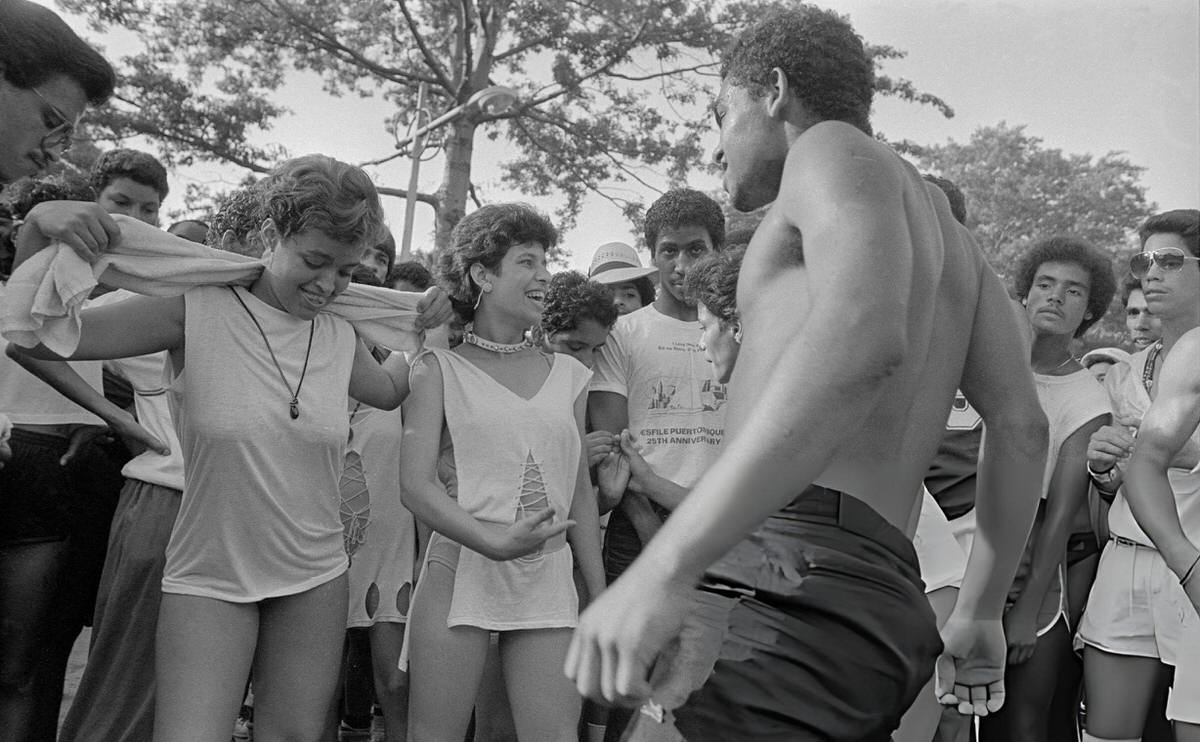 Couple Dancing As A Crowd Watches At Orchard Beach, Bronx, 1983.