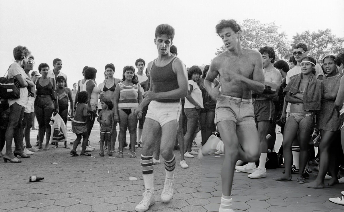 Two Young Men Dancing On The Boardwalk At Orchard Beach, Bronx, 1984.
