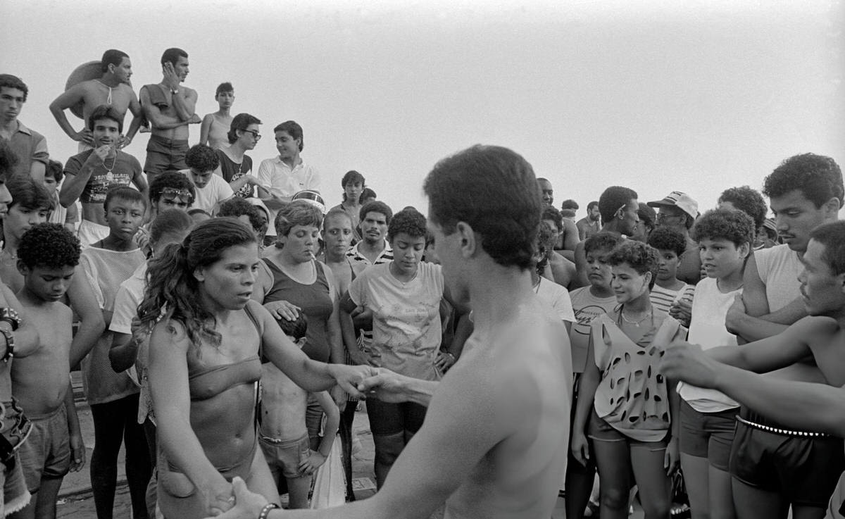 Two People Holding Hands While Dancing On The Boardwalk At Orchard Beach, Bronx, 1983.