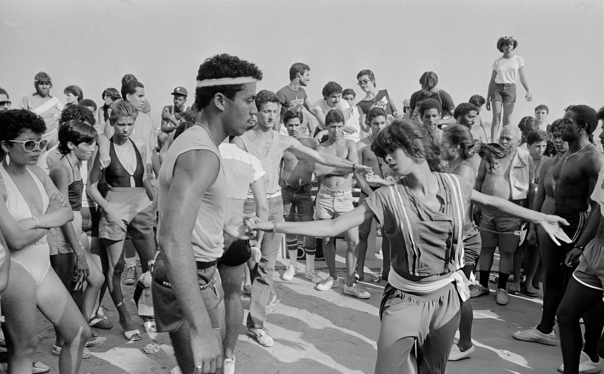 People Dancing On The Boardwalk At Orchard Beach, Bronx, 1983.