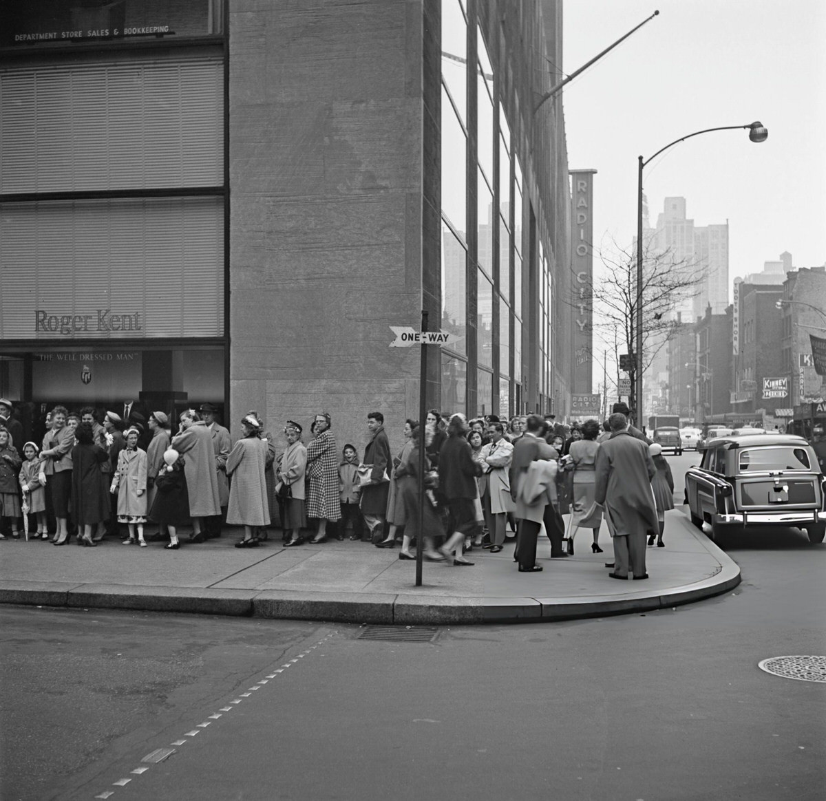 Roger Kent Men'S Clothing Store With Radio City Music Hall In The Background, New York, 1955.