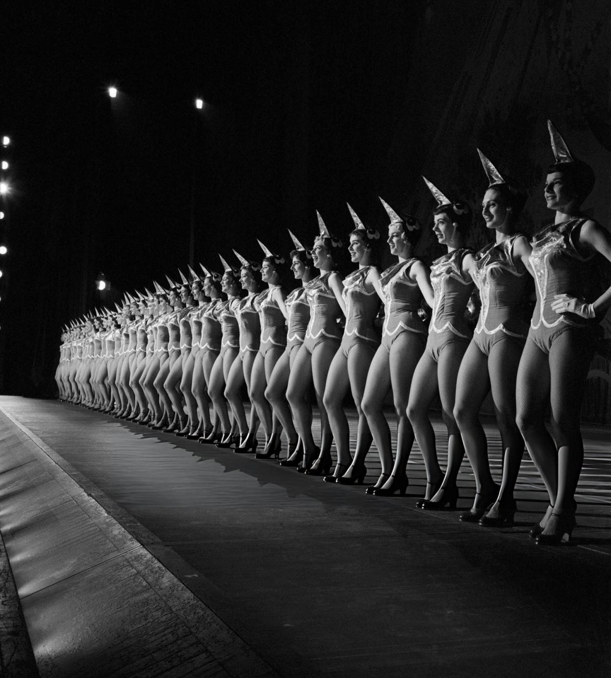 The Rockettes Lined Up In Costume On The Radio City Music Hall Stage.
