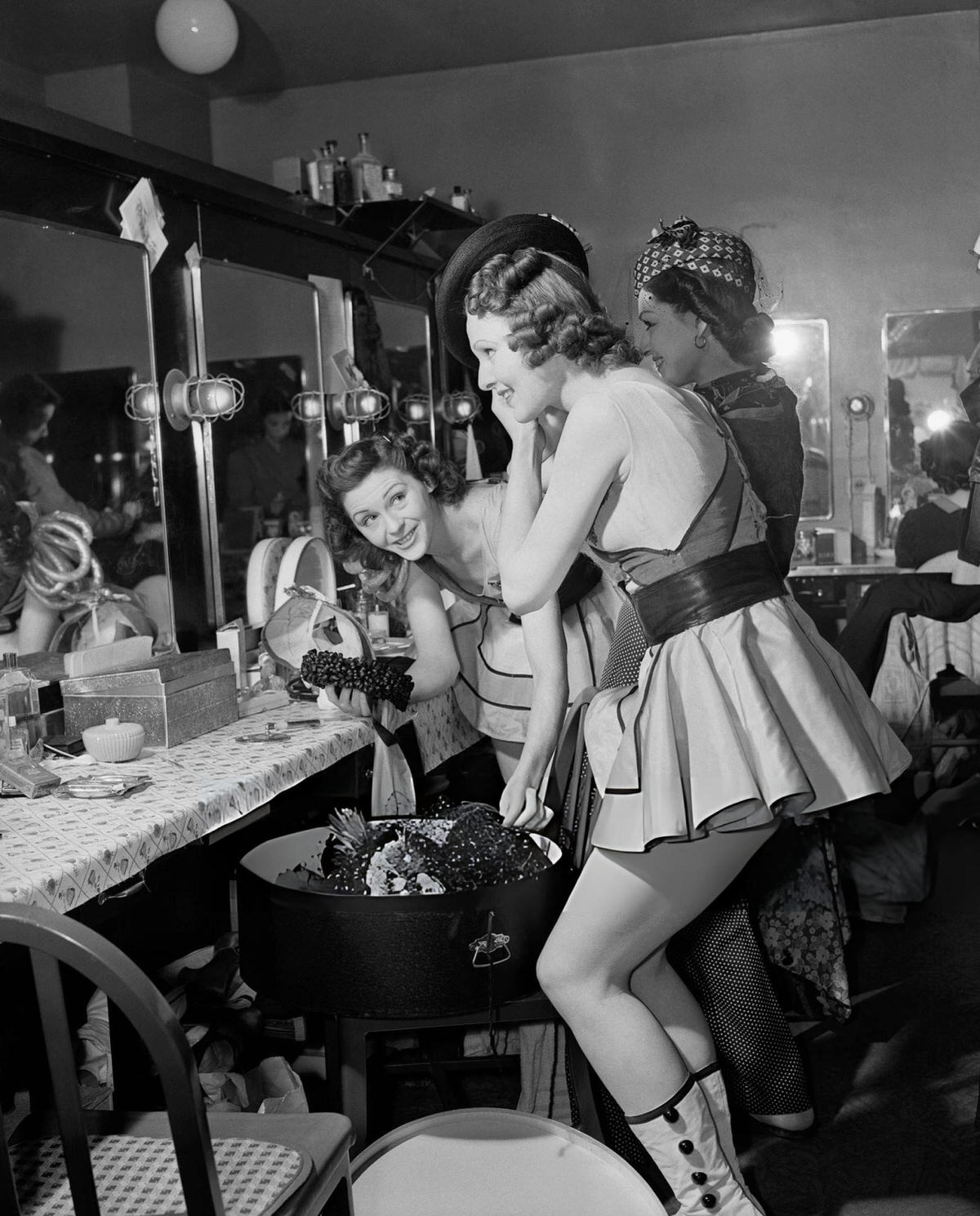 Showgirls Trying On Bonnets In A Dressing Room At Radio City Music Hall, New York.