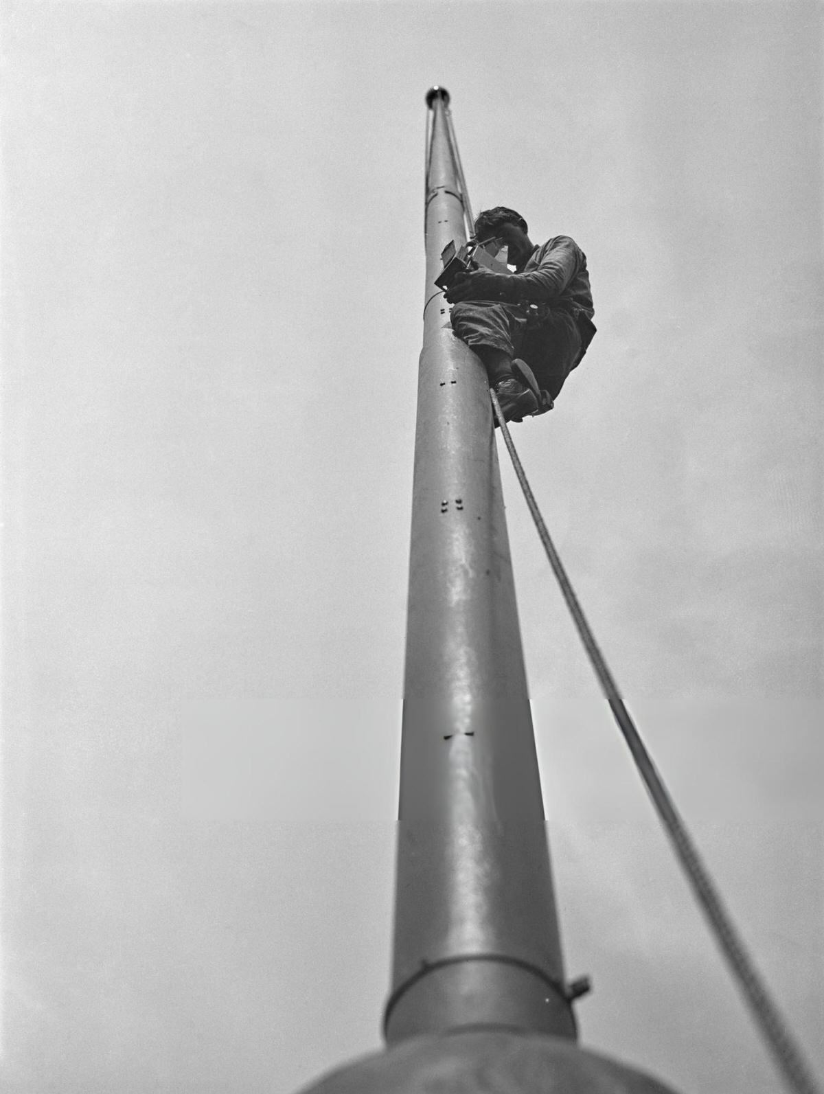Steeplejack George Nealy Taking A Photograph From The Flagpole Of The Singer Building, Manhattan, 1911.