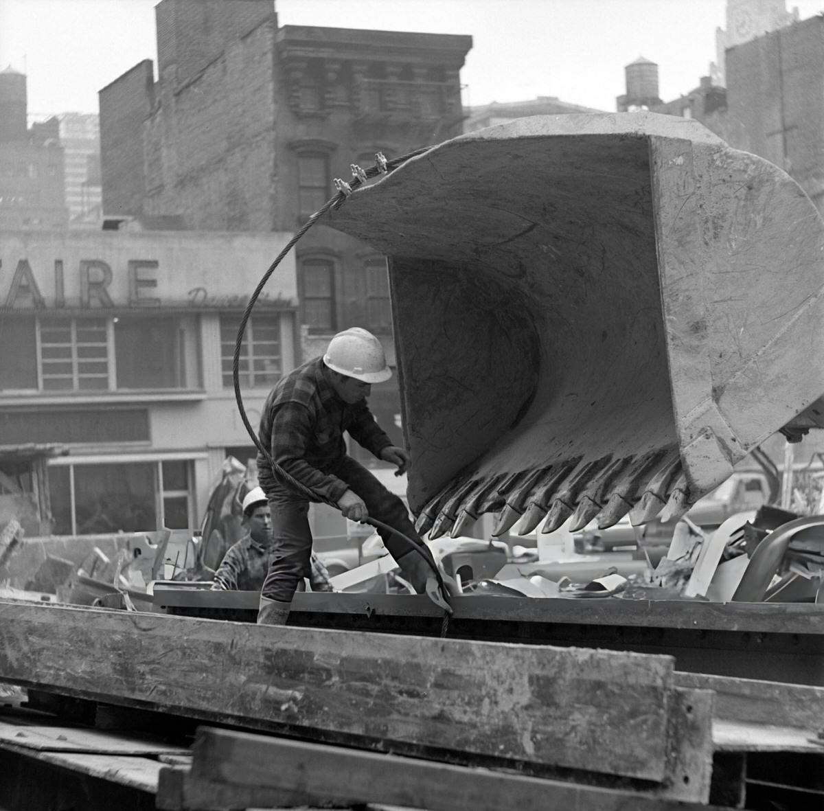 Construction Worker Inspecting A Bulldozer Scoop During The Demolition Of The Singer Building, Downtown Manhattan, 1969.
