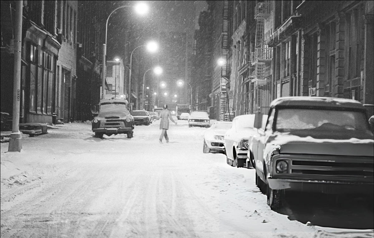 Pedestrian Crossing A Snow-Covered Street In Soho At Night, 1974.