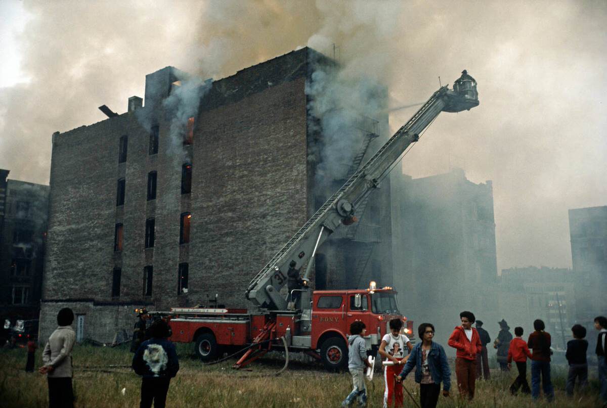 Firemen Fighting A Fire In An Abandoned Tenement Building, South Bronx, 1977.