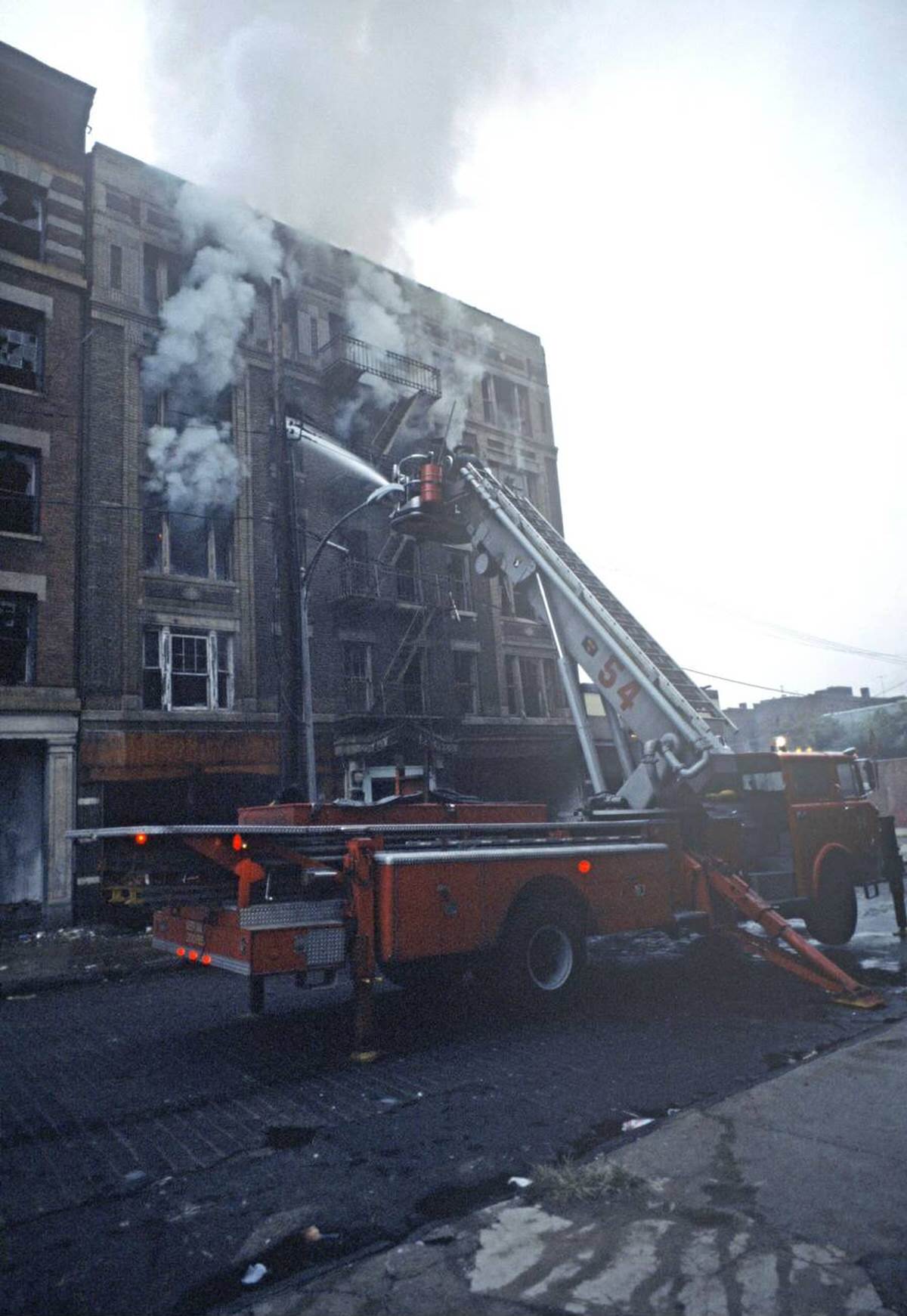 Firemen Fighting A Fire In Tenement Buildings, South Bronx, 1977.