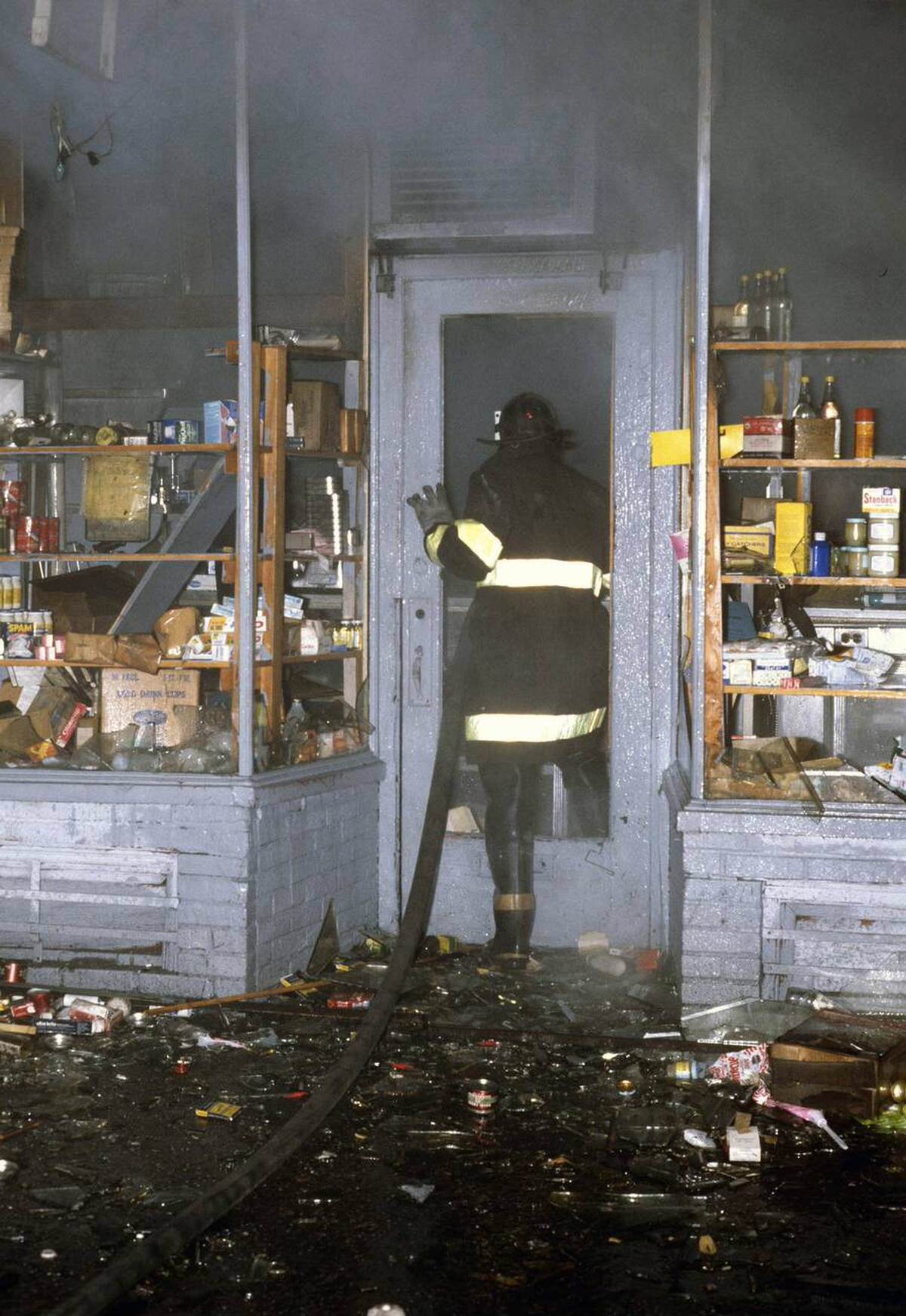 Fireman Responding To An Arson Attack At A Shop, South Bronx, 1977.