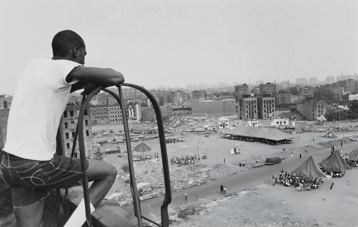 Local Resident Ron Williams Looking At Tents Erected For The People'S Convention On A Rubble-Strewn Lot, South Bronx, 1980.