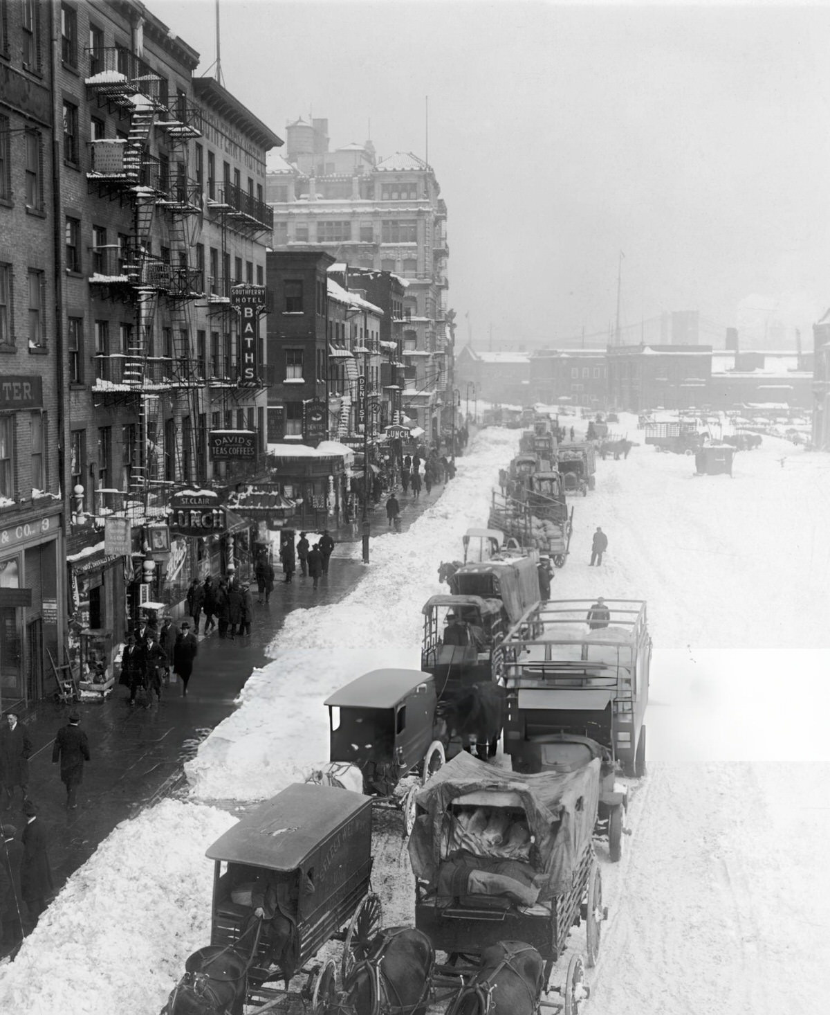 Horse-Drawn Carriages Moving Through Snow On South Street, Lower Manhattan, 1915.