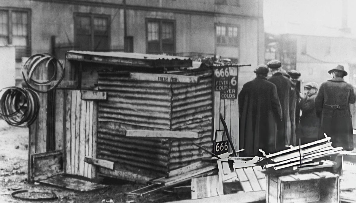 Group Standing By A Makeshift Property At Fulton And South Streets, Lower Manhattan, 1921.